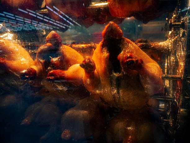 istock Stack of grilled chicken in steamy rotisserie oven machine. 2211436900