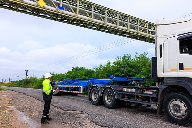 istock engineer stand use radio walkie talkie control transport trailers. 2211437211