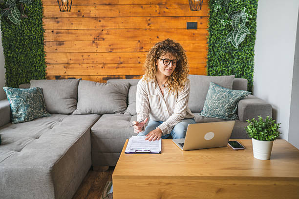 istock young adult woman use laptop and take notes in clipboard remote work 2211437921
