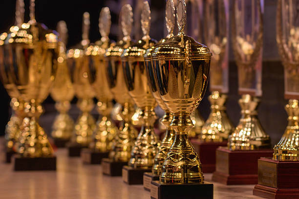 istock A row of gold and red trophies sit on a table 2211438373