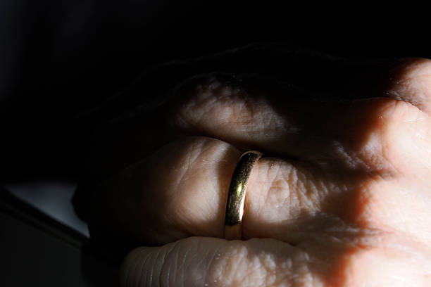 An old elder woman hand detail with wedding ring