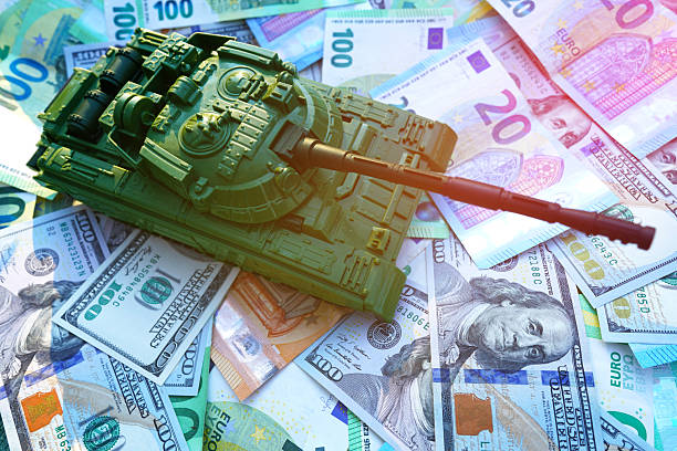 istock Tank on banknotes. Currency war. War costs, military spending. Making money war. 2211439976