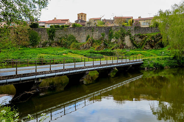 istock Old Village Wall and Bridge over Calm River in Springtime 2211440319