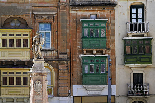 Valletta, Malta - December 25, 2023: Luxury mansions baroque style with the traditional balconies wooden in a Valletta street, Malta
