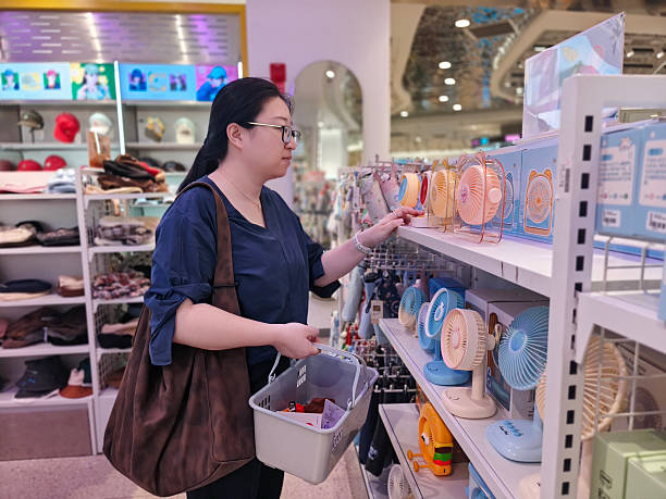 istock A woman is choosing a mini fan 2211445019