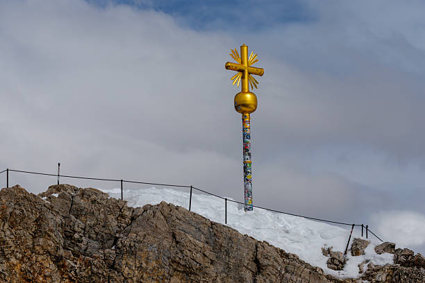Summit cross from the Zugspitze summit on the Alps on at spring. Bavarian Alps, Germany. Zugspitze Ski Resort. Spring in the Bavarian Alps.