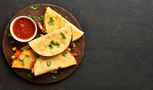 istock Delicious quesadilla with fresh vegetables served with tomato sauce 2211447507