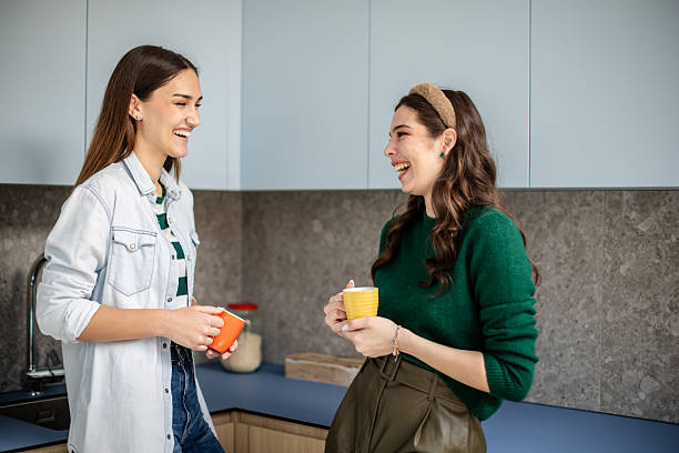istock Friends enjoy a lively conversation over coffee in their cozy apartment kitchen during a sunny day 2211447539
