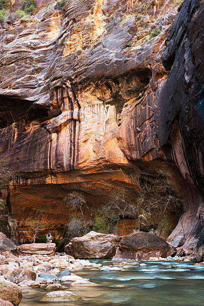 istock Woman photographing a canyon river 2211447852