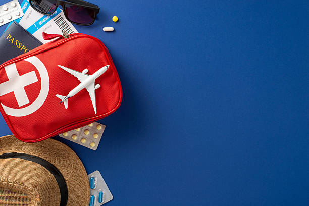 istock Travel setup including a first aid kit, medications, hat, and documents suggesting holiday preparation 2211449193