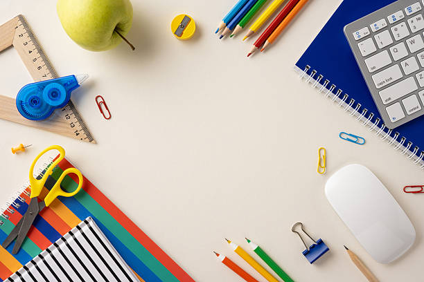 istock Collection of school supplies arranged neatly on a beige surface, emphasizing creativity and learning 2211449256