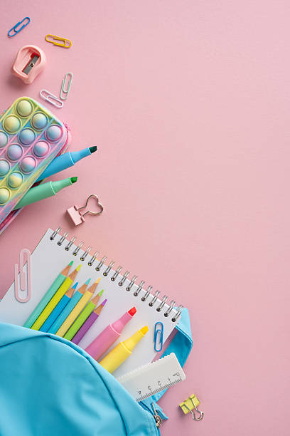 istock School vertical supplies including pencils, markers, and a notebook in a backpack layout 2211449264