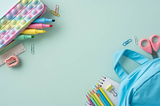 istock School supplies arranged on a pastel background with a backpack promoting back to school theme 2211449270