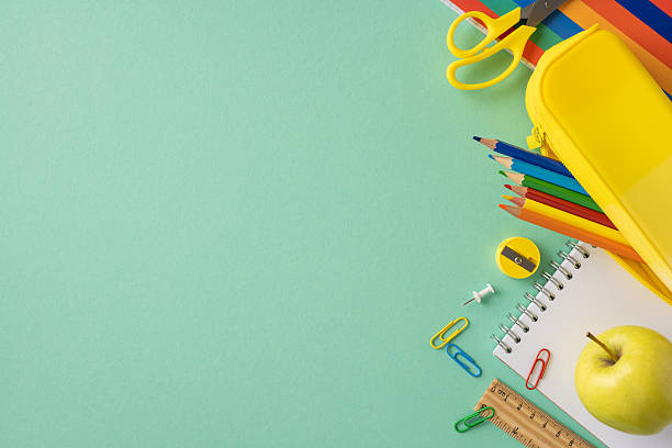 istock Bright and colorful school supplies including pencils, notepad, and apple placed creatively 2211449307