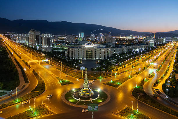 Sun sets over the Turkmen State Institute of Culture (Medeniyet Instituty) and other buildings in the Creative Town district of Ashgabat, Turkmenistan. Viewed from the Sport Hotel.