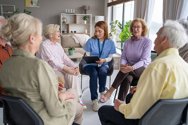 istock Group Therapy Session with Caring Professional and Seniors 2211451228