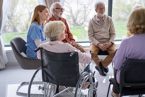istock Seniors Engaged in Conversation with a Caregiver Present 2211451255