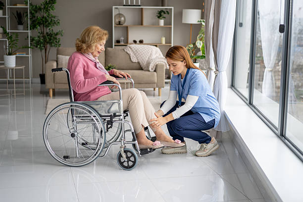 istock Caring Aid: Health Assistant Helping Elderly Woman 2211451323