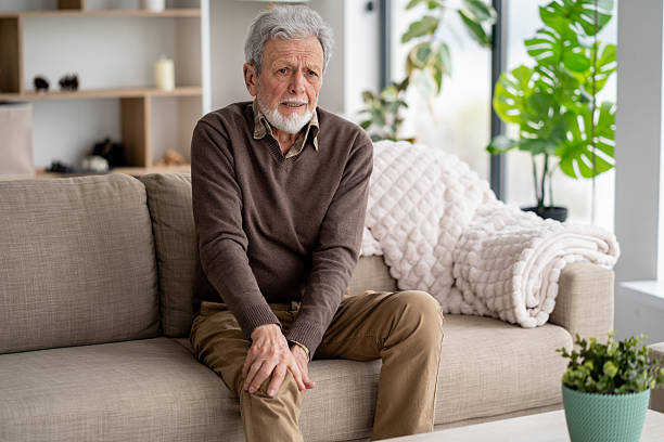 istock Elderly Man Sitting on Couch with Gentle Smile 2211451400