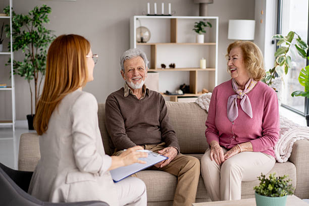 istock Elderly couple discussing with a consultant at home 2211451409