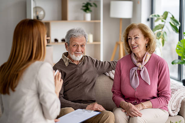 istock Engaged discussion between elderly couple and female advisor 2211451413