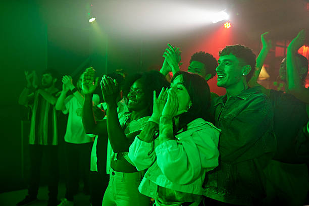 istock Cheering and applauding fans at nightclub performance 2211453998