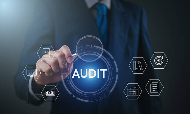 istock Businessman performing financial audit with magnifying glass on digital dashboard using virtual interface, showcasing data analysis, compliance, and corporate risk management. 2211455078
