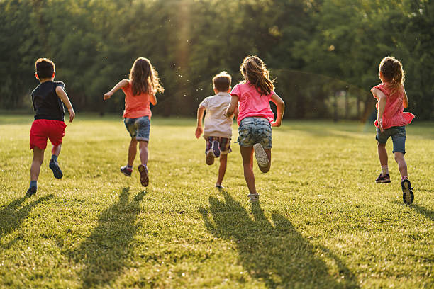 istock Group of kids running in nature 2211455700