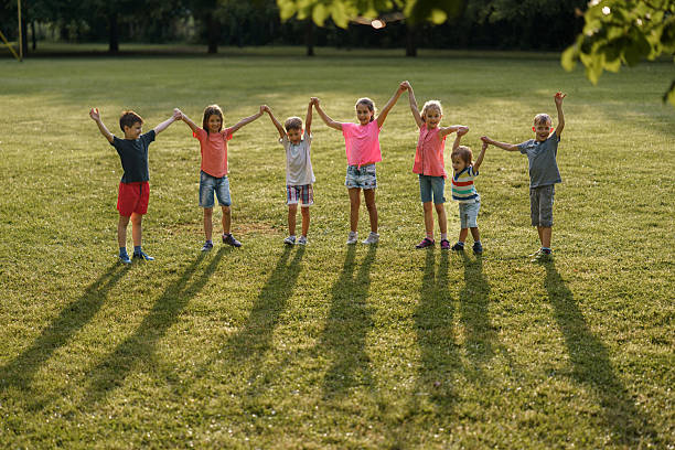 istock Children whit raised hands in the nature 2211456062