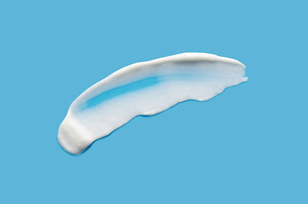 istock A sample of white cosmetic moisturizer on a blue background 2211456317