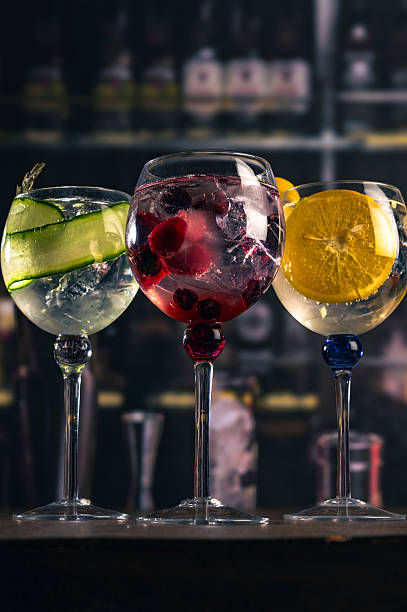 istock Garnished cocktails lined up on a bar 2211457339