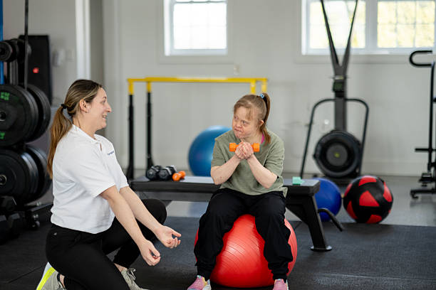 istock Personal Trainer Assisting Individual with Disability During Gym Workout Session 2211459172