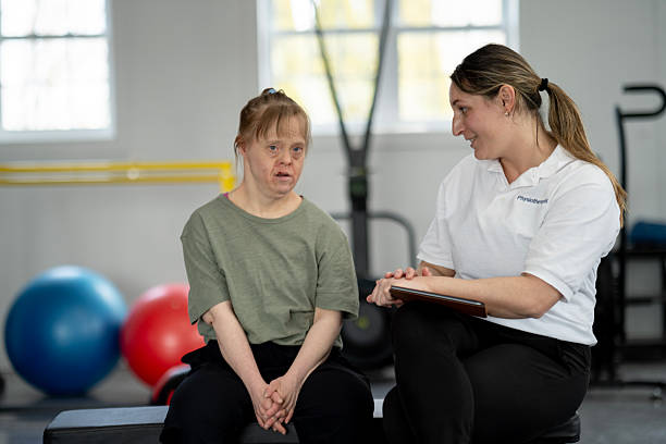 istock Personal Trainer Assisting a Client with Exercises in a Gym Setting 2211459203
