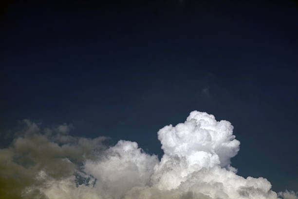 istock Dramatic Sky with Fluffy Clouds Against Dark Backdrop in Nature 2211459348
