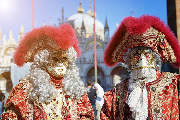 Venice, Italy - February 12, 2023: Portrait of woman wearing colorful mask and costume during the annual Venice Carnival in Venice, Italy