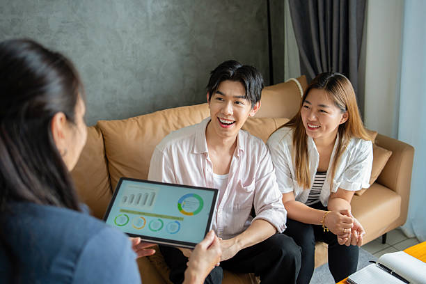 istock financial advisor advising young couple at home 2211461808