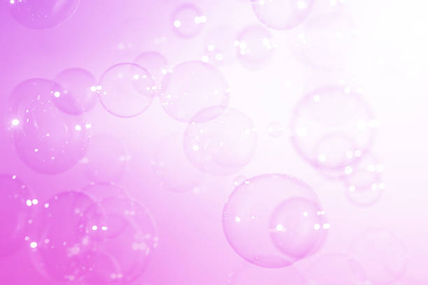 Beautiful Purple Soap Bubbles Floating in The Air. Celebration Festive Backdrop. Freshness Soap Suds Bubbles Water. Purple and White Gradient Textured. Abstract Background.