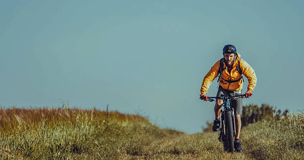 istock Man mountainbiking on a grassy trail 2211466837