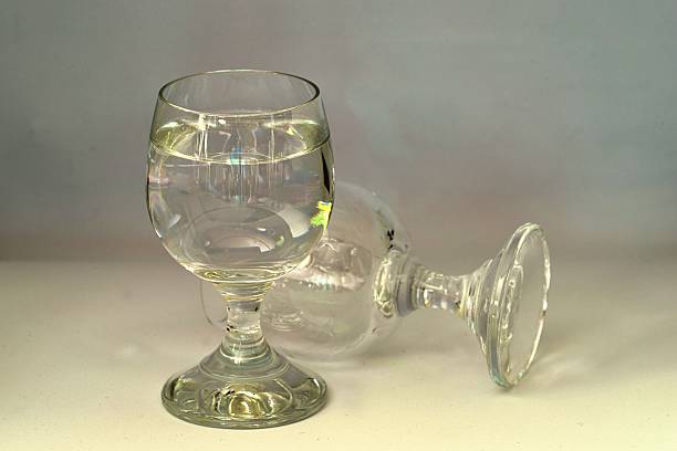 istock a full vodka glass and an empty vodka glass turned upside down symbolizing decline, alcoholism 2211468617