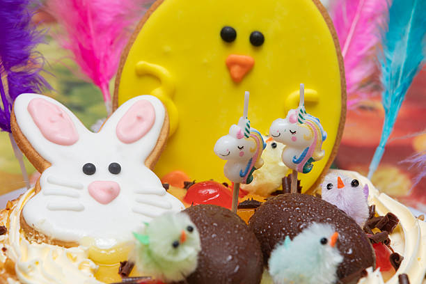 Easter cake detail full with color, chocolate eggs, feathers and candied fruits.