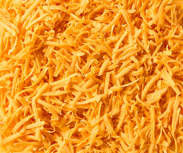 istock Grated cheddar cheese close up background. 2211472023