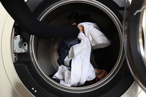 istock Washing machine and colorful laundry,Filling washing machine 2211473514