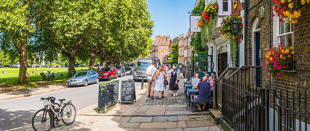 People outside the pubs and on the leafy pavements of Richmond upon Thames outside London, UK.