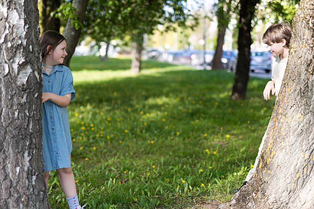 istock Young girl and boy in park 2211477609