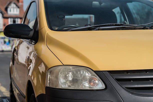 Nantwich, Cheshire, England, April 4th 2025. A close-up of a yellow Volkswagen Fox headlight.