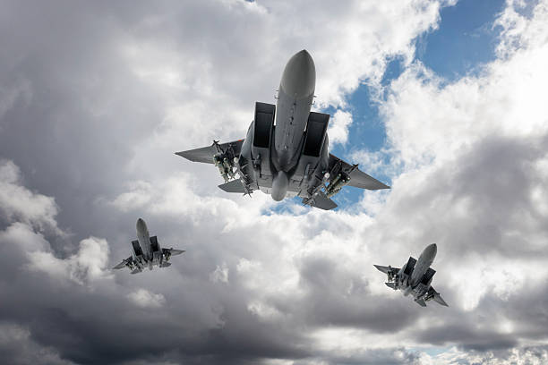 istock F-15 Jet Fighters flying over clouds. 2211479666