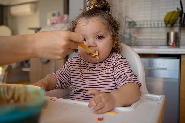 istock Toddler Being Fed by Mother at Home 2211488694