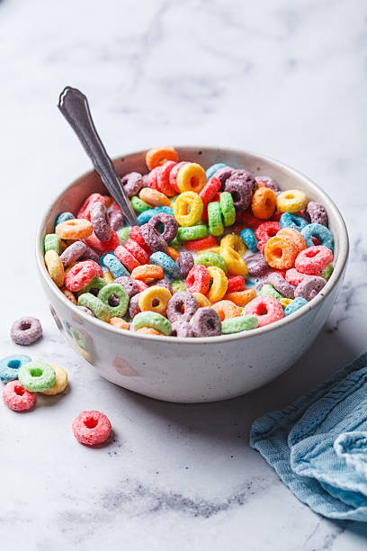 istock Colorful fruit cereal in bowl on white marble background. 2211490121