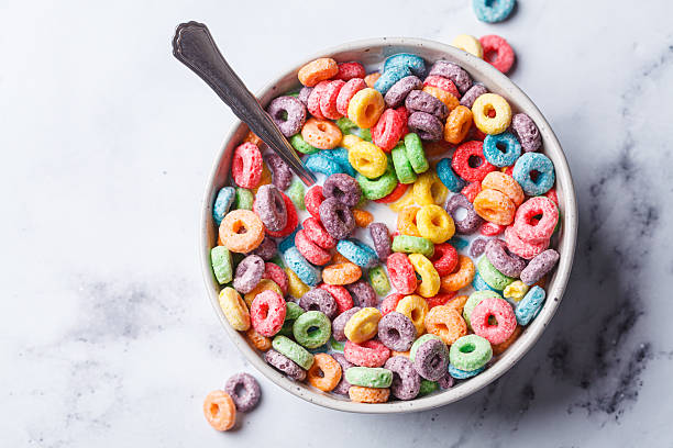istock Colorful fruit cereal in bowl on white marble background. 2211490148