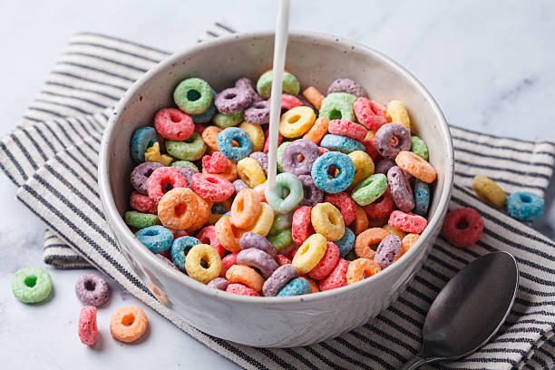 istock Colorful fruit cereal in bowl on white marble background. 2211490183